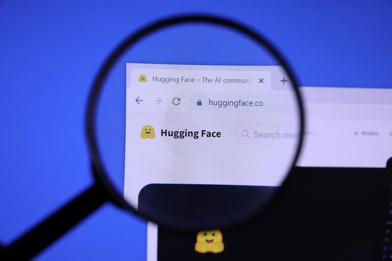A magnifying glass enlarging a browser tab and address bar showing the huggingface.co homepage