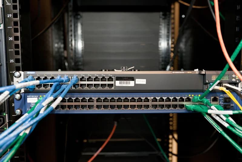 Close view of densely cabled rack servers with network cables and status lights in a data centre
