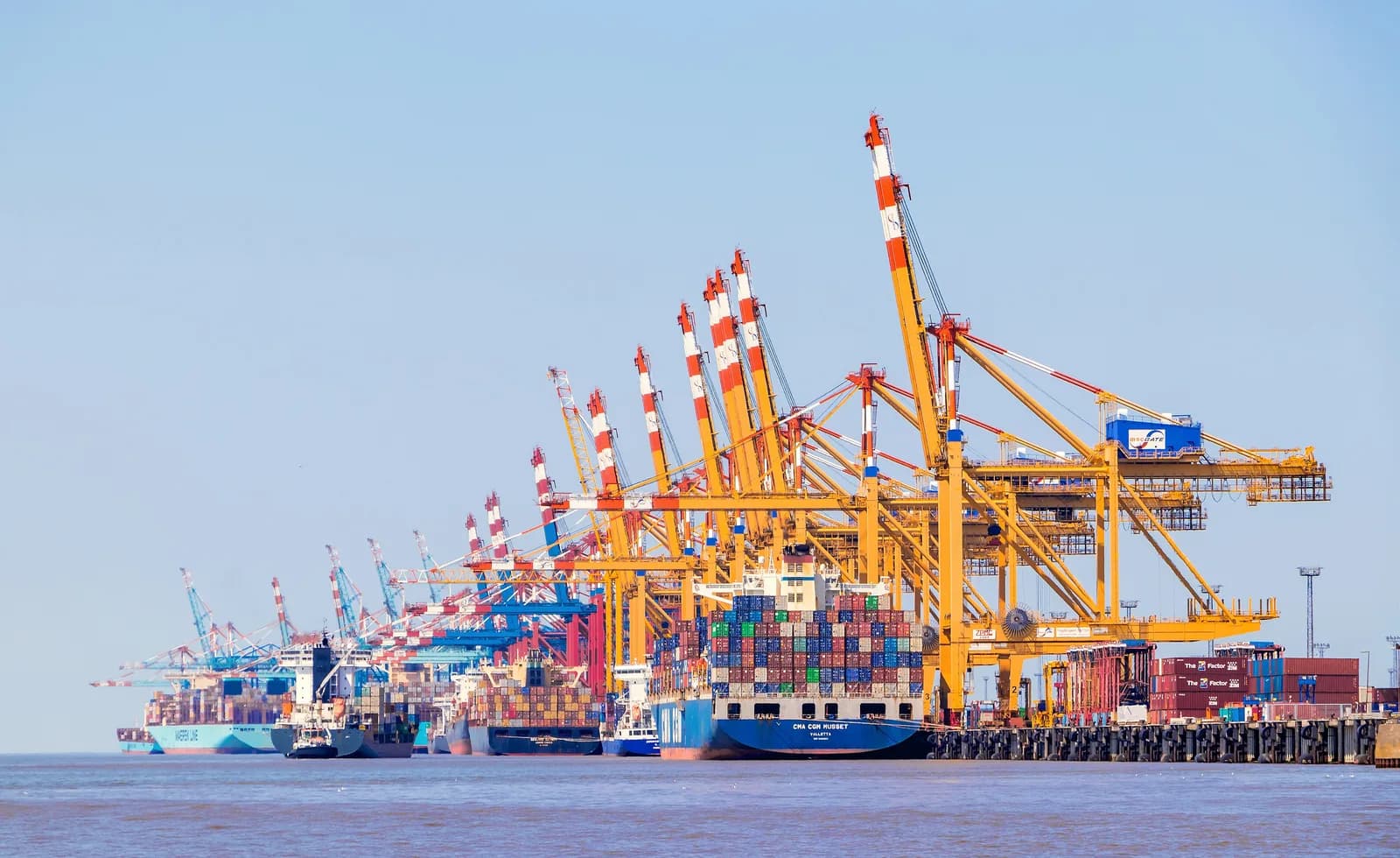 Stacked shipping containers and gantry cranes at the container terminal in Bremerhaven, Germany