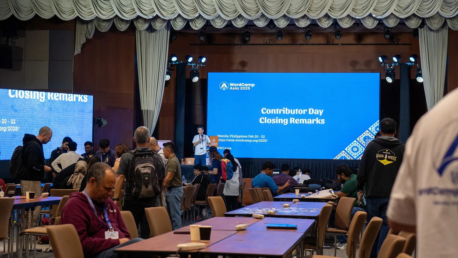 WordPress contributors gathered in a large hall at the end of Contributor Day at WordCamp Asia 2025