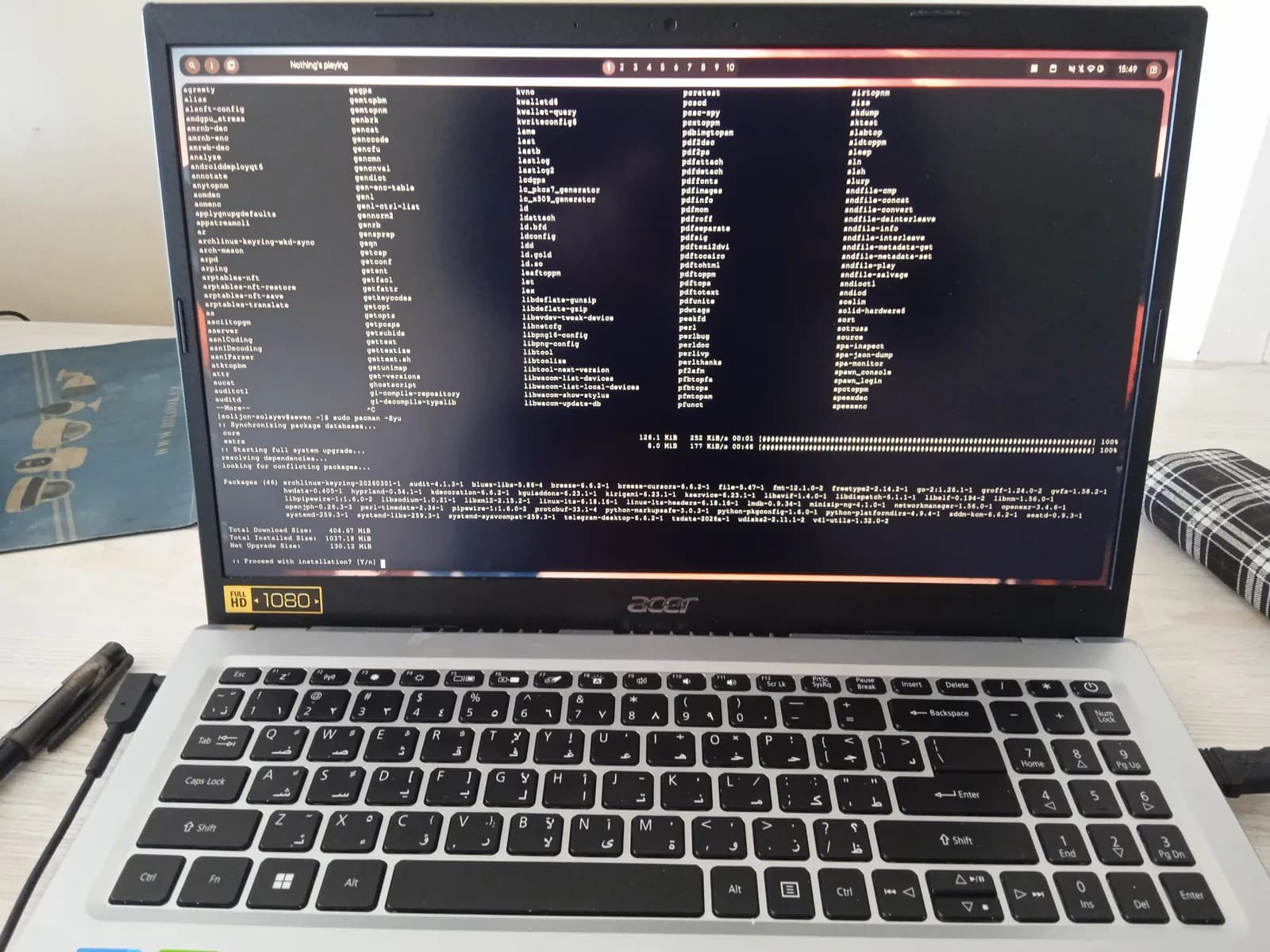 Laptop on a desk with a terminal window full of command output filling the screen