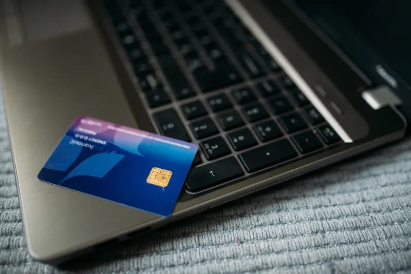 Blue chip bank card resting on the keyboard of an open laptop