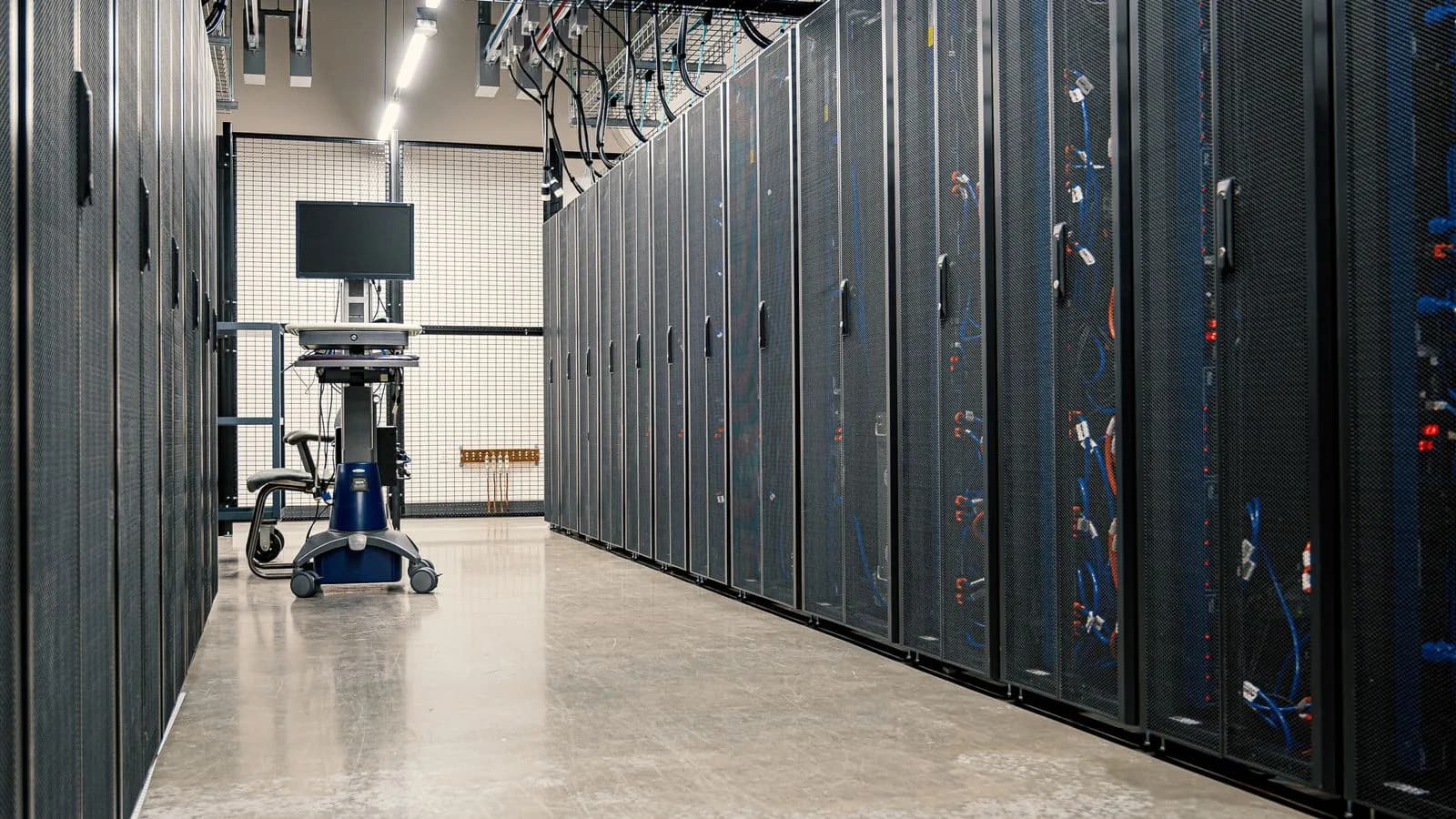 Server racks and networking equipment in a data centre corridor.