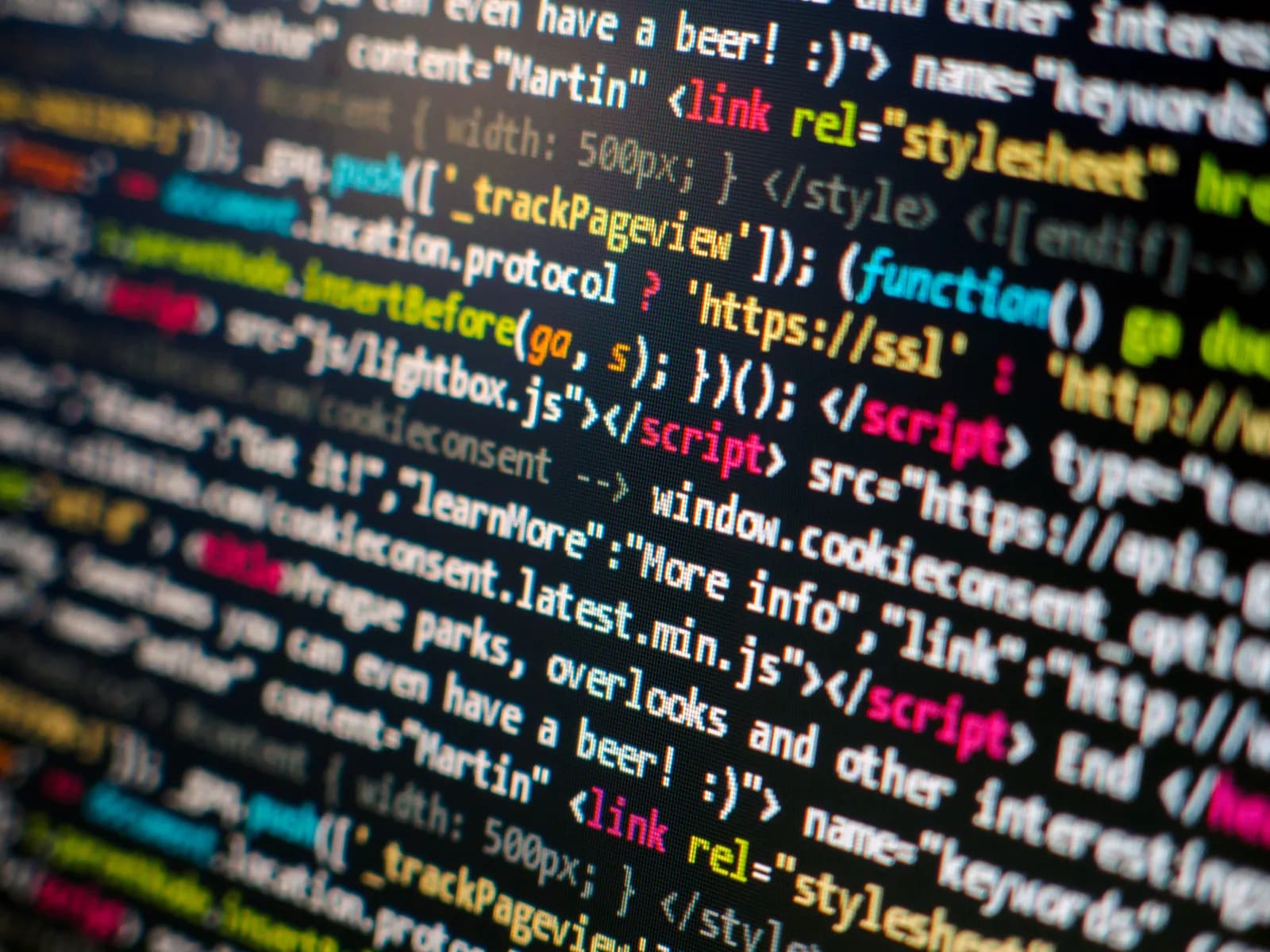 Close-up of colourful JavaScript and HTML source code on a monitor.