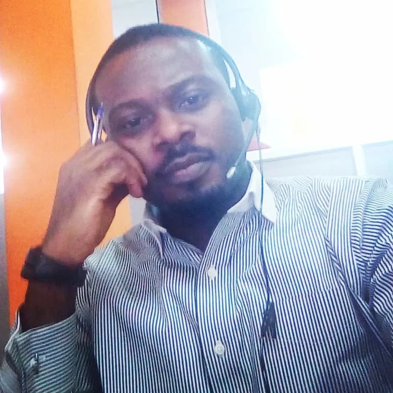 Customer support agent wearing a headset at a help desk.