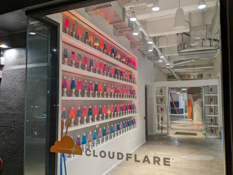 Wall of lava lamps in the entrance of a Cloudflare office.